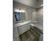 Bathroom featuring granite countertop, white cabinets, and shower and bathtub combo at 420 S Hamilton Ave, Indianapolis, IN 46201