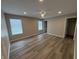 A spacious bedroom features hardwood floors, a ceiling fan, natural light, and neutral paint at 420 S Hamilton Ave, Indianapolis, IN 46201