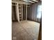 Unfinished bedroom with exposed wood framing and closet space at 420 S Hamilton Ave, Indianapolis, IN 46201