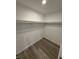 A simple closet features hardwood floors and shelves for clothing and storage at 420 S Hamilton Ave, Indianapolis, IN 46201