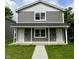 Charming two-story duplex with gray siding, white trim and inviting front porches at 420 S Hamilton Ave, Indianapolis, IN 46201