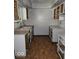 Spacious kitchen needing work with unfinished cabinets, countertops, and wood flooring at 4235 Foxglove Trce, Indianapolis, IN 46237