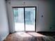 Sliding glass door opens onto a deck from a room with damaged flooring at 4235 Foxglove Trce, Indianapolis, IN 46237