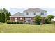 Manicured lawn with lovely landscaping and an outdoor deck, ideal for leisure at 4415 Summer Dr, Zionsville, IN 46077