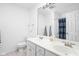 A full bathroom with double sinks, framed mirror and shower with blue curtain at 4415 Summer Dr, Zionsville, IN 46077