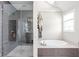 Bathroom featuring a frameless shower, soaking tub, and neutral tile work at 4415 Summer Dr, Zionsville, IN 46077