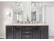 Bathroom with double vanity sinks, modern fixtures, and a large mirror at 4415 Summer Dr, Zionsville, IN 46077