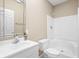 Clean bathroom with a white sink, toilet, and shower-tub combo, with light beige walls at 4415 Summer Dr, Zionsville, IN 46077