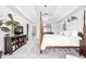 Spacious bedroom with a four-poster bed, TV, and decorative shelving at 4415 Summer Dr, Zionsville, IN 46077