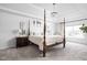 A primary bedroom features a four-poster bed, elegant lighting, and bright windows at 4415 Summer Dr, Zionsville, IN 46077