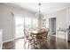 Bright dining room with a chandelier and sliding glass doors leading to a patio at 4415 Summer Dr, Zionsville, IN 46077