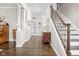 Inviting foyer with hardwood floors, staircase, and elegant decor at 4415 Summer Dr, Zionsville, IN 46077