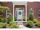 Close-up of the front door with a decorative wreath and manicured landscaping at 4415 Summer Dr, Zionsville, IN 46077