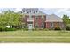 Beautiful two-story brick home with a well-manicured lawn and inviting front porch at 4415 Summer Dr, Zionsville, IN 46077