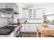 Gourmet kitchen boasts stainless steel appliances, white cabinetry, and hardwood floors at 4415 Summer Dr, Zionsville, IN 46077