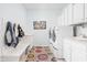 Bright laundry room with modern appliances, ample storage, and colorful rug at 4415 Summer Dr, Zionsville, IN 46077