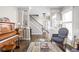 Inviting living room with a piano, decorative rug, and comfortable armchair with view at 4415 Summer Dr, Zionsville, IN 46077