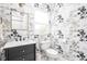 Stylish powder room with floral wallpaper, dark vanity and gold framed mirror at 4415 Summer Dr, Zionsville, IN 46077
