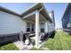 Covered patio with furniture and a grill, perfect for outdoor entertaining at 485 Washington St, Fortville, IN 46040
