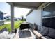 Comfortable covered back porch featuring seating and a grill at 485 Washington St, Fortville, IN 46040