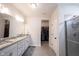 Bright bathroom featuring granite countertops, double sinks, and a glass-enclosed shower at 485 Washington St, Fortville, IN 46040