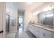 Bright bathroom with double sinks, granite countertops, glass-enclosed shower, and access to bedroom at 485 Washington St, Fortville, IN 46040