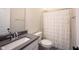 Bathroom featuring a neutral color palette, single sink with granite countertops, toilet, and shower at 485 Washington St, Fortville, IN 46040