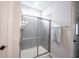 Bathroom showcases a modern glass-enclosed shower with sleek fixtures and tile at 485 Washington St, Fortville, IN 46040
