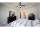 Bedroom boasts neutral tones, ceiling fan, and doors leading to the bathroom and walk-in closet at 485 Washington St, Fortville, IN 46040