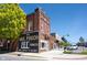 Classic brick building featuring vintage advertising mural and storefronts on a sunny day at 485 Washington St, Fortville, IN 46040