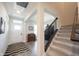 Bright foyer with a staircase, light gray floors, and an open layout at 485 Washington St, Fortville, IN 46040