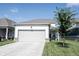 Charming home featuring an attached garage, driveway, and beautiful lawn at 485 Washington St, Fortville, IN 46040