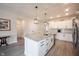 Modern kitchen showcasing a large island with granite countertops and stainless steel appliances, offering style and functionality at 485 Washington St, Fortville, IN 46040