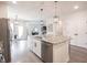 Bright kitchen features granite countertops, stainless steel appliances, and a large island with barstool seating at 485 Washington St, Fortville, IN 46040