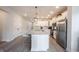 Bright kitchen features an island with barstool seating, stainless steel appliances, and ample cabinet space at 485 Washington St, Fortville, IN 46040