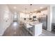 Open kitchen with a large island featuring barstool seating and stainless appliances, perfect for entertaining at 485 Washington St, Fortville, IN 46040