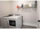 Laundry room with washer, dryer, and storage shelf at 485 Washington St, Fortville, IN 46040