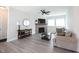 Bright living room with stone fireplace, ceiling fan, and gray wood-look floors at 485 Washington St, Fortville, IN 46040