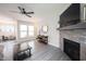 Open-concept living room with fireplace and view into adjoining rooms at 485 Washington St, Fortville, IN 46040
