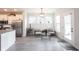 Open-concept living space features bright living room adjacent to a modern kitchen with stainless appliances at 485 Washington St, Fortville, IN 46040