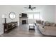 Bright living room with stone fireplace, ceiling fan, and gray wood-look floors at 485 Washington St, Fortville, IN 46040