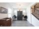 Open floor plan with office space, gray floors, and staircase access at 485 Washington St, Fortville, IN 46040