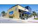 Charming restaurant exterior with yellow walls, outdoor seating, and blue umbrellas on a sunny day at 485 Washington St, Fortville, IN 46040