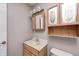 Well-lit bathroom features a single sink vanity, storage cabinets, and decorative floral accents at 494 W Greencastle Rd, Mooresville, IN 46158