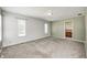Spacious bedroom with large windows, neutral carpet, and ensuite bathroom at 494 W Greencastle Rd, Mooresville, IN 46158