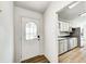 Welcoming entryway with a decorative glass door, leading into a kitchen with white cabinets at 494 W Greencastle Rd, Mooresville, IN 46158