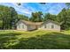 Rear exterior view of the single-story home with neutral siding, and manicured lawn at 494 W Greencastle Rd, Mooresville, IN 46158