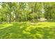 Expansive front yard surrounded by mature trees providing shade and privacy to the home at 494 W Greencastle Rd, Mooresville, IN 46158