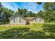Charming single-story home with verdant lawn, surrounded by mature trees and a blue sky at 494 W Greencastle Rd, Mooresville, IN 46158