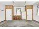 The garage has carpeting and white walls and cabinets and a refrigerator in the back at 494 W Greencastle Rd, Mooresville, IN 46158